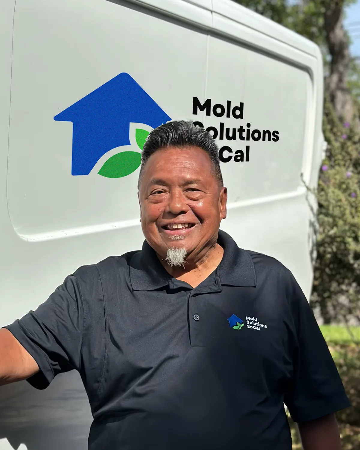 Raymond Alemania, founder of Mold Solutions SoCal, beside the company van